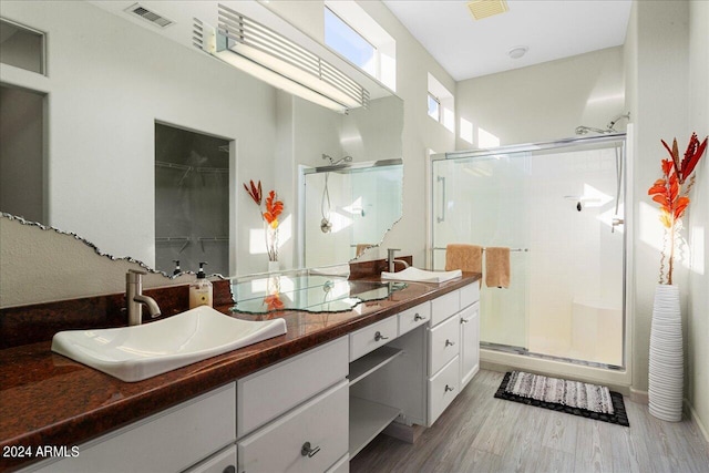 bathroom featuring vanity, hardwood / wood-style floors, and an enclosed shower