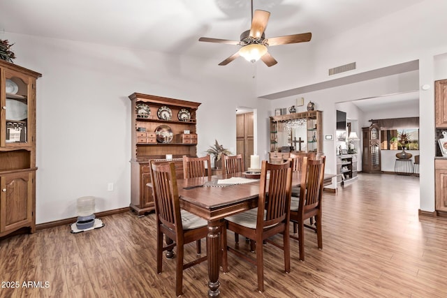 dining room with ceiling fan and light wood-type flooring