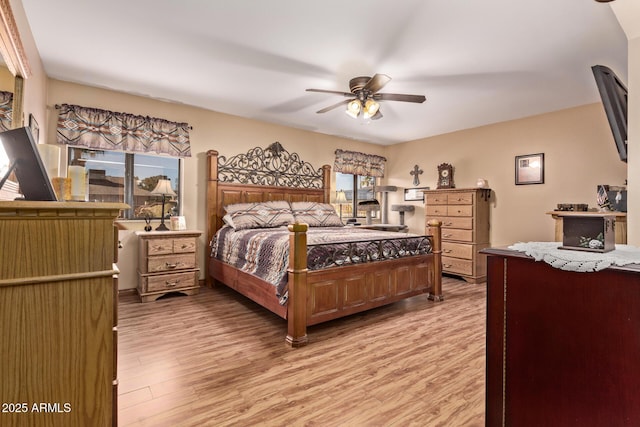 bedroom with light hardwood / wood-style floors and ceiling fan