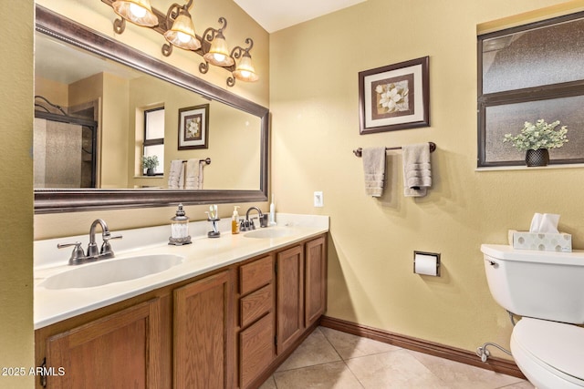 bathroom featuring tile patterned floors, toilet, a shower with shower door, and vanity