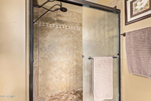 bathroom featuring a shower with door