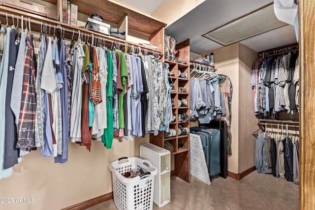 walk in closet with tile patterned flooring