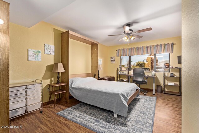 bedroom with hardwood / wood-style floors and ceiling fan