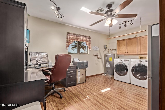 office featuring light hardwood / wood-style flooring, rail lighting, ceiling fan, electric water heater, and washing machine and clothes dryer