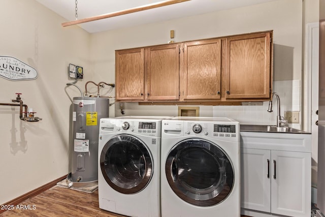 washroom featuring sink, water heater, cabinets, dark hardwood / wood-style floors, and independent washer and dryer