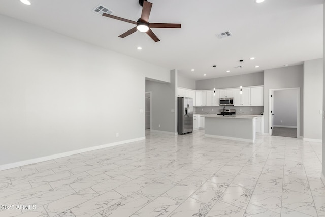 unfurnished living room featuring ceiling fan