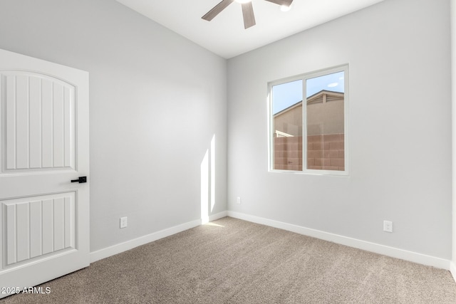 carpeted spare room with ceiling fan