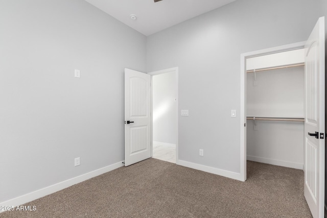 unfurnished bedroom with carpet floors and a closet