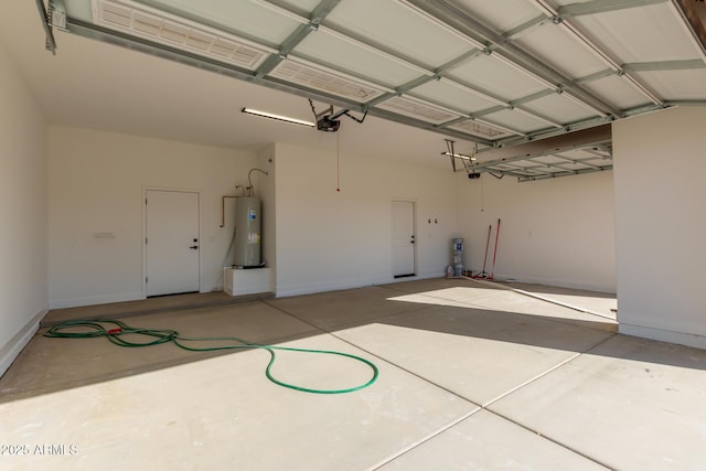 garage with electric water heater and a garage door opener