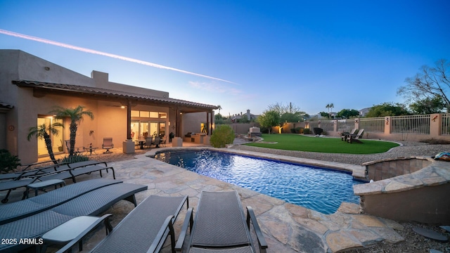 view of swimming pool featuring a yard and a patio area