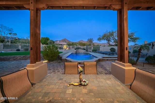 exterior space with pool water feature, a mountain view, and a patio area