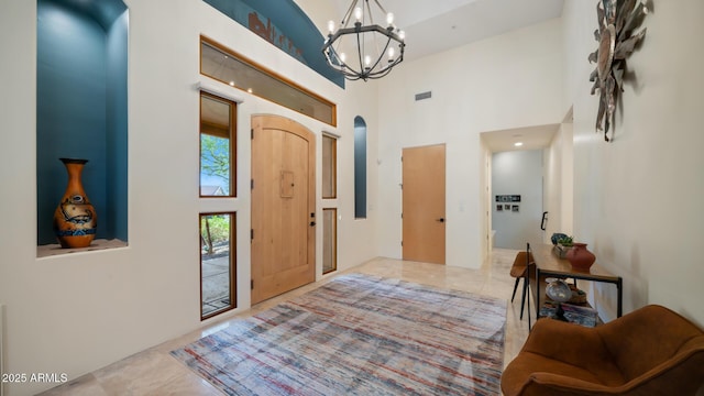 foyer with a high ceiling and a chandelier