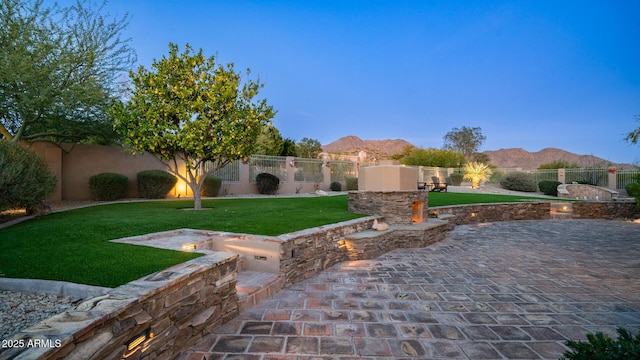 view of yard featuring a patio and a mountain view