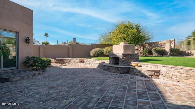 view of patio featuring an outdoor stone fireplace