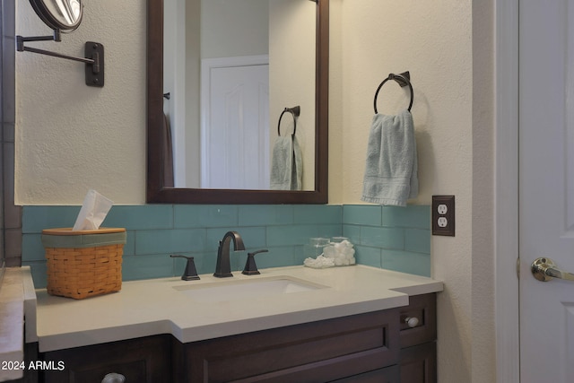 bathroom featuring vanity and tasteful backsplash