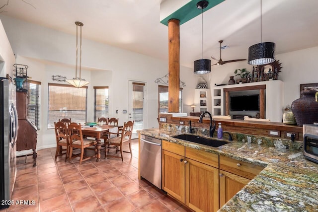 43014 N 12th St, New River, AZ 85087 - kitchen with a sink, appliances with stainless steel finishes, open floor plan, hanging light fixtures, and dark stone countertops