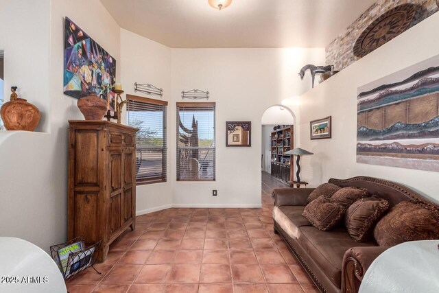 43014 N 12th St, New River, AZ 85087 - living area with tile patterned floors, a towering ceiling, and baseboards