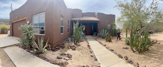 43014 N 12th St, New River, AZ 85087 - pueblo revival-style home featuring stucco siding, driveway, and a garage