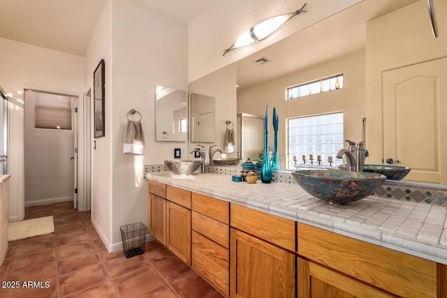 43014 N 12th St, New River, AZ 85087 - full bath featuring a shower stall, tile patterned floors, double vanity, and baseboards