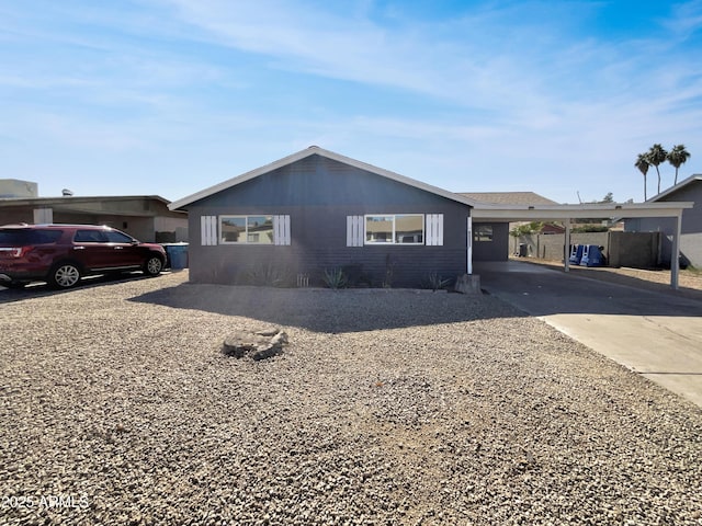 ranch-style home with an attached carport and concrete driveway