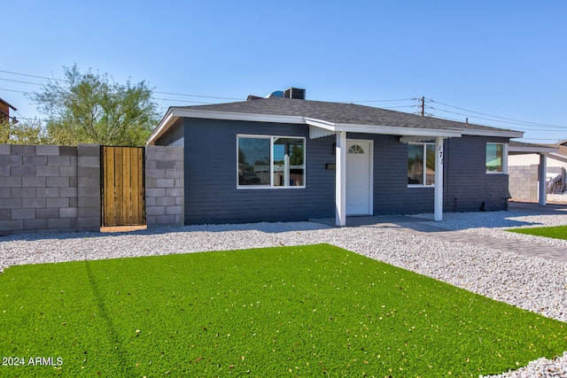 single story home featuring central AC unit and a front lawn