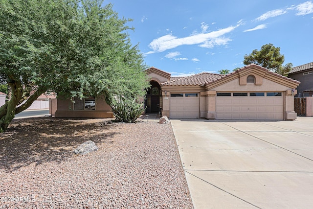 656 W Johnson Dr, Gilbert, AZ 85233 - view of front of home featuring driveway, a garage, a tiled roof, and stucco siding