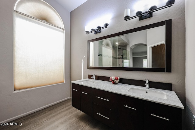 656 W Johnson Dr, Gilbert, AZ 85233 - bathroom with baseboards, wood finished floors, double vanity, and a sink