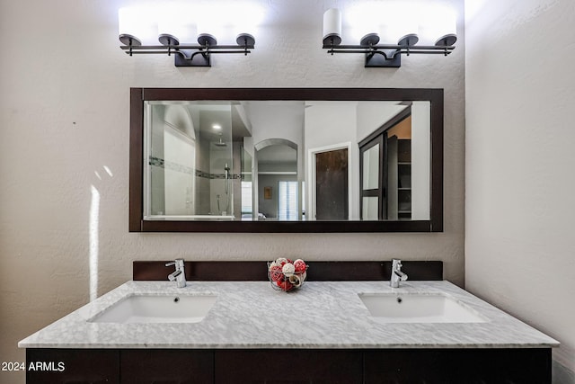 656 W Johnson Dr, Gilbert, AZ 85233 - bathroom featuring a textured wall, a sink, and a stall shower