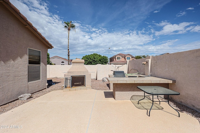 656 W Johnson Dr, Gilbert, AZ 85233 - view of patio with a fenced backyard, a grill, area for grilling, and exterior fireplace