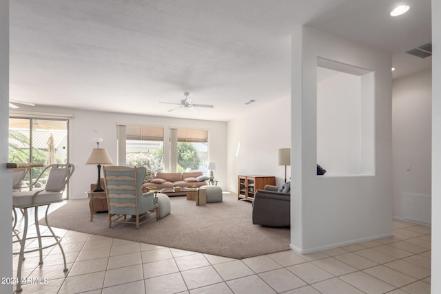 tiled living room with ceiling fan