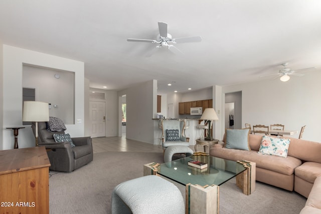 carpeted living room featuring ceiling fan