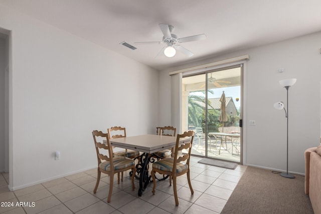 tiled dining area with ceiling fan