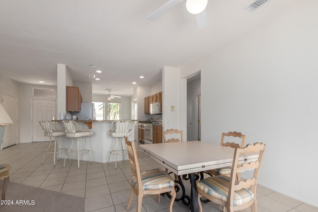 dining area featuring light tile patterned floors and ceiling fan