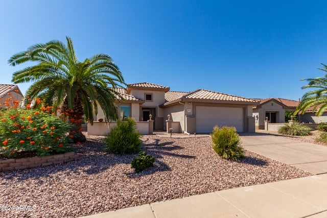 mediterranean / spanish-style home with a garage