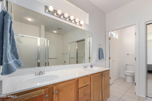 bathroom with vanity, a shower with shower door, toilet, and tile patterned floors