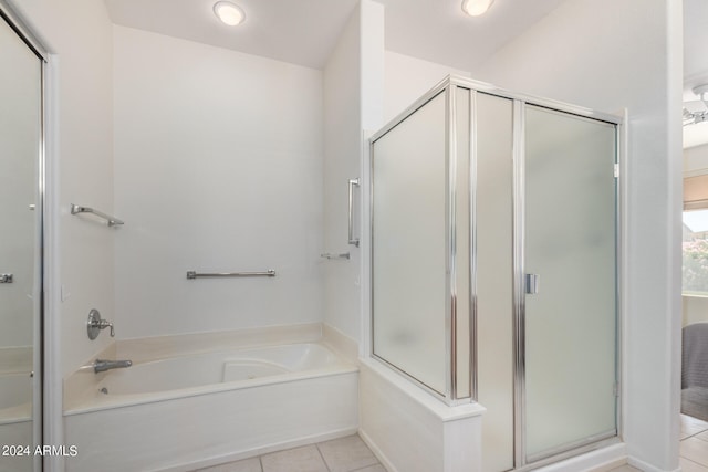 bathroom featuring shower with separate bathtub and tile patterned flooring