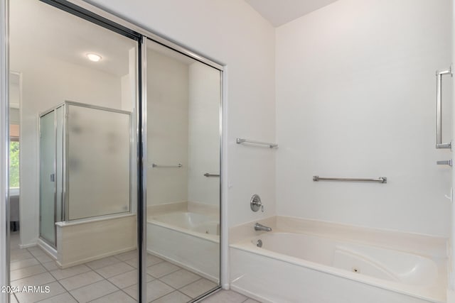 bathroom featuring tile patterned flooring and separate shower and tub