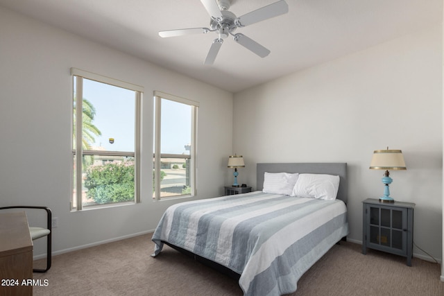 carpeted bedroom featuring multiple windows and ceiling fan