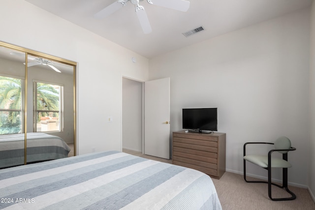 carpeted bedroom with a closet and ceiling fan