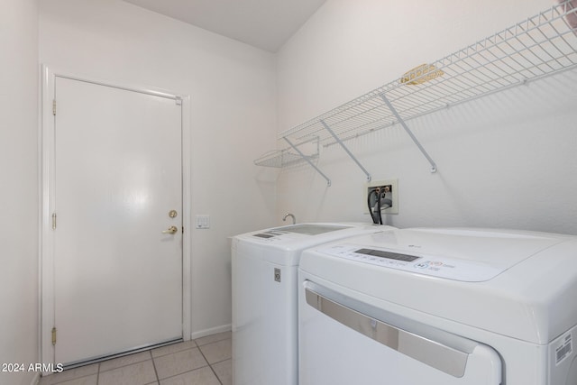 clothes washing area featuring light tile patterned floors and independent washer and dryer