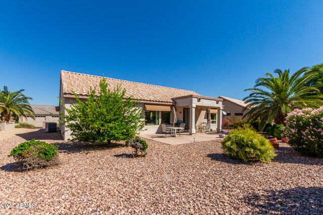 back of property featuring a patio and cooling unit