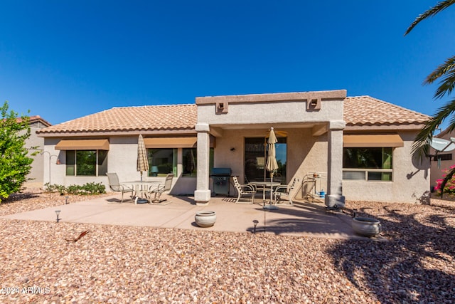 back of property with a patio