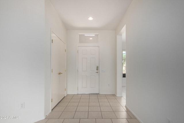 entryway with light tile patterned flooring