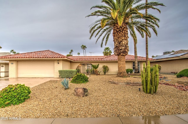 view of front of house featuring a tiled roof, an attached garage, driveway, and stucco siding