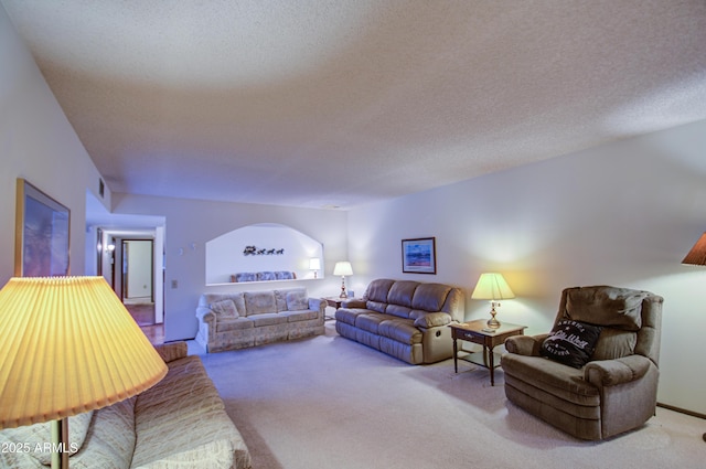 carpeted living room with a textured ceiling