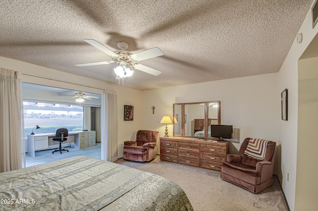 bedroom featuring access to exterior, visible vents, ceiling fan, light carpet, and a textured ceiling