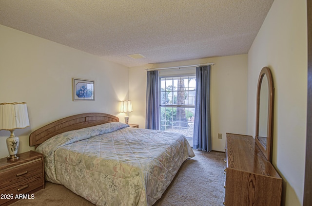 carpeted bedroom with a textured ceiling