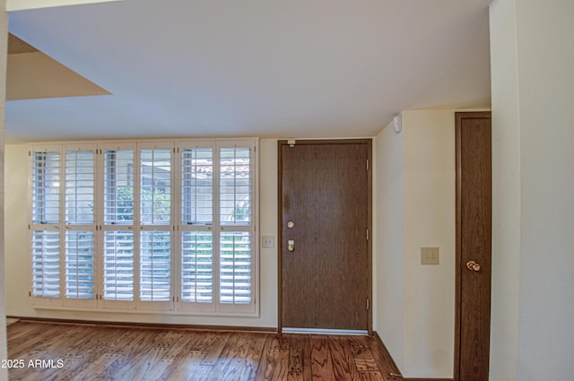 entrance foyer featuring wood finished floors and baseboards