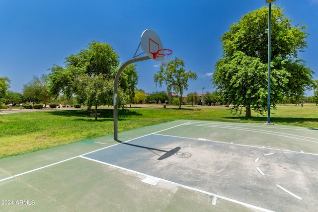 view of sport court with a yard