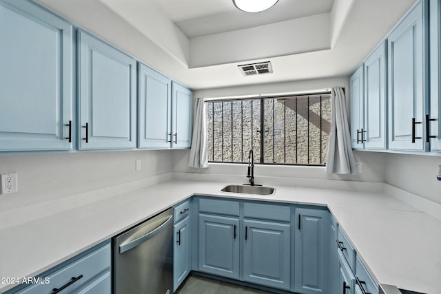 kitchen with stainless steel dishwasher, blue cabinets, and sink